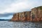 Vladivostok, the red rocks of the Popov island in cloudy weather