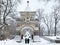 Vladivostok, Russia, March, 05,2020. People walking near Triumphal Nicholas, Nikolaevskaya arch of Tsarevich in snowfall in earl