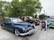 Vladivostok, Russia, May, 18, 2019. People walkingg on Exhibition of American retro-cars near Buick Road Master 1950 year of manuf