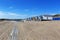 Vlissingen - beautiful sandy beach with colorful houses in a row. In the middle of the path of wooden planks. Sunny, quiet,
