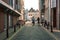 Vlissingen, the Netherlands - April 2015: Street view with modern red brick buildings and two ladies cycling