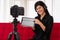 Vlog Asian woman blogger influencer sitting on the sofa in home and recording video blog for teaching and coach her Students or