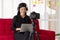 Vlog Asian woman blogger influencer sitting on the sofa in home and recording video blog for teaching and coach her Students or