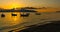 VLORA - VLORE, ALBANIA: Beautiful sunset on the sea, silhouettes of fishing boats.