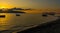 VLORA - VLORE, ALBANIA: Beautiful sunset on the sea, silhouettes of fishing boats.