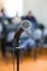 Vocal Microphone in focus against blurred audience at the conference