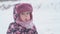 vocation, game, childhood concept - slo-mo authentic happy preschool toddler baby girl in hat and mittens licking