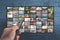 VOD service on television. TV streaming concept. man holding remote control with many icons of video service on demand on