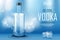 Vodka bottle with ice cubes ad. Strong alcohol drink mock up on shiny blue background and water splash and drops. Vodka