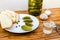 Vodka, pickled cucumbers, bread and garlic on a wooden table