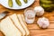 Vodka, pickled cucumbers, bread and garlic on a wooden table