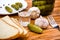 Vodka, pickled cucumbers, bread and garlic on a wooden table