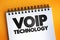 Voip Technology text quote on notepad, concept background