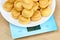 A vol-au-vent dish lies on the blue scales. Calorie counting concept, figure tracking