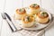 Vol-au-Vent is a hollow puff pastry shell filled with a creamy mushroom and chicken filling closeup on the plate. Horizontal