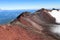 Volcan slope covered with old red lava rocks