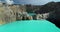 A volcanic crater Kelimutu lakes with turquoise water closeup. Aerial flight over azure aqua