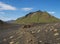 Volcanic desert landscape with green Hattafell mountain with footpatj of Laugavegur trail. Fjallabak Nature Reserve