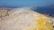 Volcanic gas exiting through fumaroles on Fossa crater of Vulcano island. Lipari Islands. Mediterranean sea, blue sky