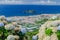 Volcanic Island Vila Franca in the background of blooming flowers and cityscape view of Sao Miguel