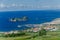 Volcanic Island Vila Franca in the background of cityscape view of Sao Miguel, Azores