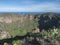 Volcanic landscape of Caldera de Bandama crater with circular hiking trail. Gran Canaria, Spain. Sunny day, blue sky.