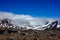 Volcanic landscape with mountains covered by Snowand low hanging clouds