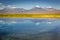 Volcanic landscape and salt lake reflection at sunset in Atacama Desert, Chile