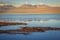 Volcanic landscape and salt lake reflection at sunset in Atacama Desert, Chile