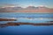 Volcanic landscape and salt lake reflection at sunset in Atacama Desert, Chile