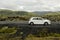 Volcanic lava fields covered in moss and a car