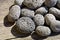 Volcanic lava pebbles background, porous lava stone textured surface