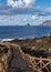 Volcanic pathway with wooden railing, with Roques de Salmor background