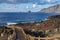 Volcanic pathway with wooden railing, with Roques de Salmor background