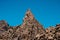 Volcanic rock , layered volcanic rock in desert with mountain landscape and blue sky