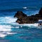 Volcanic rock, surf, and blue water on the Maui coaset