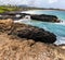 Volcanic Shoreline of Shipwreck Beach with Ha\\\'upu Ridge In The Distance