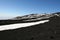 Volcanic soil, snow and sky on the top of Etna