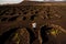 Volcanic vineyard with woman running