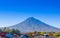 Volcano Agua above the roofs of old quarters of Antigua in a beautiful sunny day and blue sky in the city of Antigua