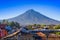 Volcano Agua above the roofs of old quarters of Antigua in a beautiful sunny day and blue sky in the city of Antigua