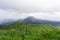 Volcano Agung or Gunung Agung on a rainy day. Low clouds over a sacred volcano and jungle. Lava traces on the slopes of the mount.