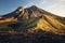 volcano at dusk casting long shadows