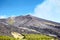 Volcano Etna, Sicily, Italy. Slopes with road and cableway. Crater of Etna. Smoking peak of active volcano Etna