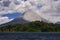 Volcano with exhalation and ash. Beautiful tropic landscape with volcano. Cone active volcano, Central America. Active Arenal with