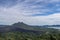 Volcano landscape with lava fields, pine tree forest and farms and houses on the slopes. Kintamani is a village on the western