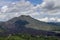 Volcano landscape with lava fields, pine tree forest and farms and houses on the slopes. Kintamani is a village on the western