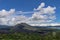 Volcano landscape with lava fields, pine tree forest and farms and houses on the slopes. Kintamani is a village on the western