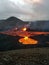 Volcano with lava pouring into the air from a crater