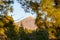 Volcano mountain raising in a distance above pine forest.